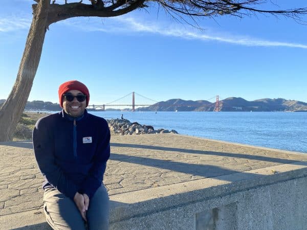 Akuhata sitting in front of the Golden Gate Bridge, San Fransisco.